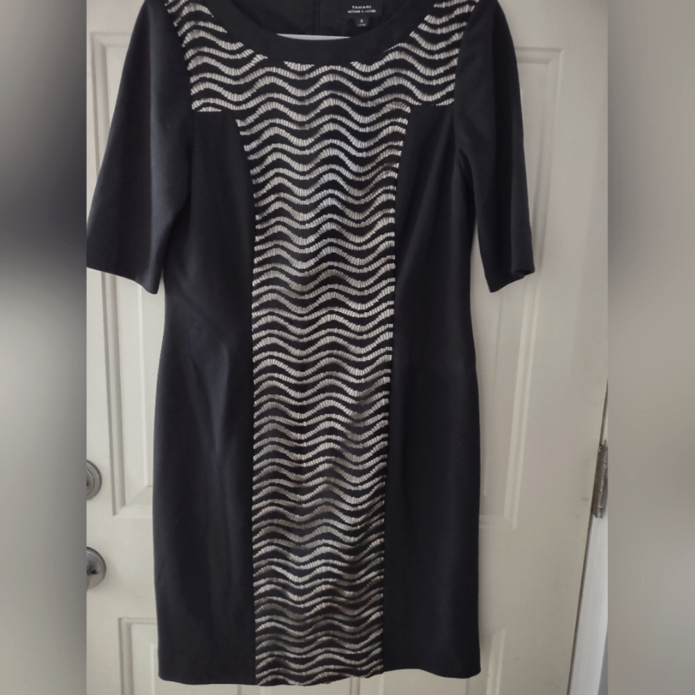 Elegant and modern. Has a classic silhouette with some sheer wavey lace
